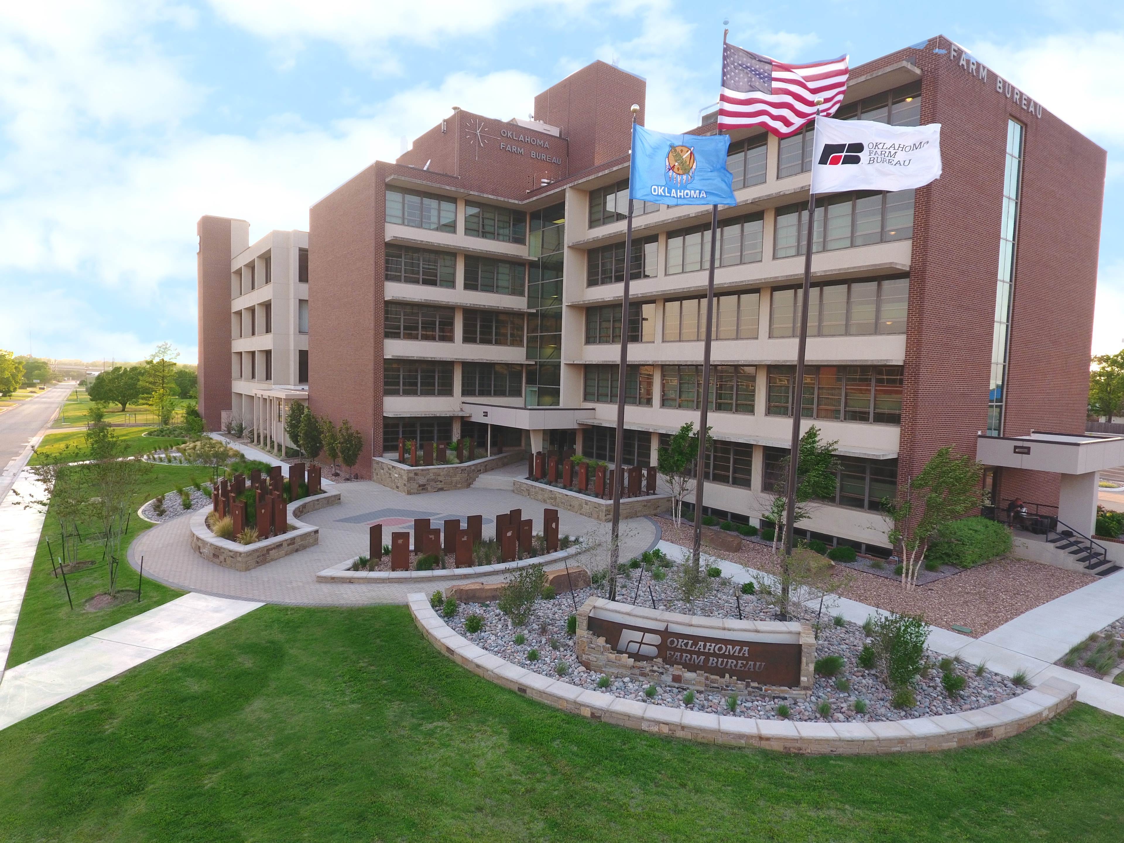 Oklahoma Farm Bureau headquarters aerial view with landscaping and flags