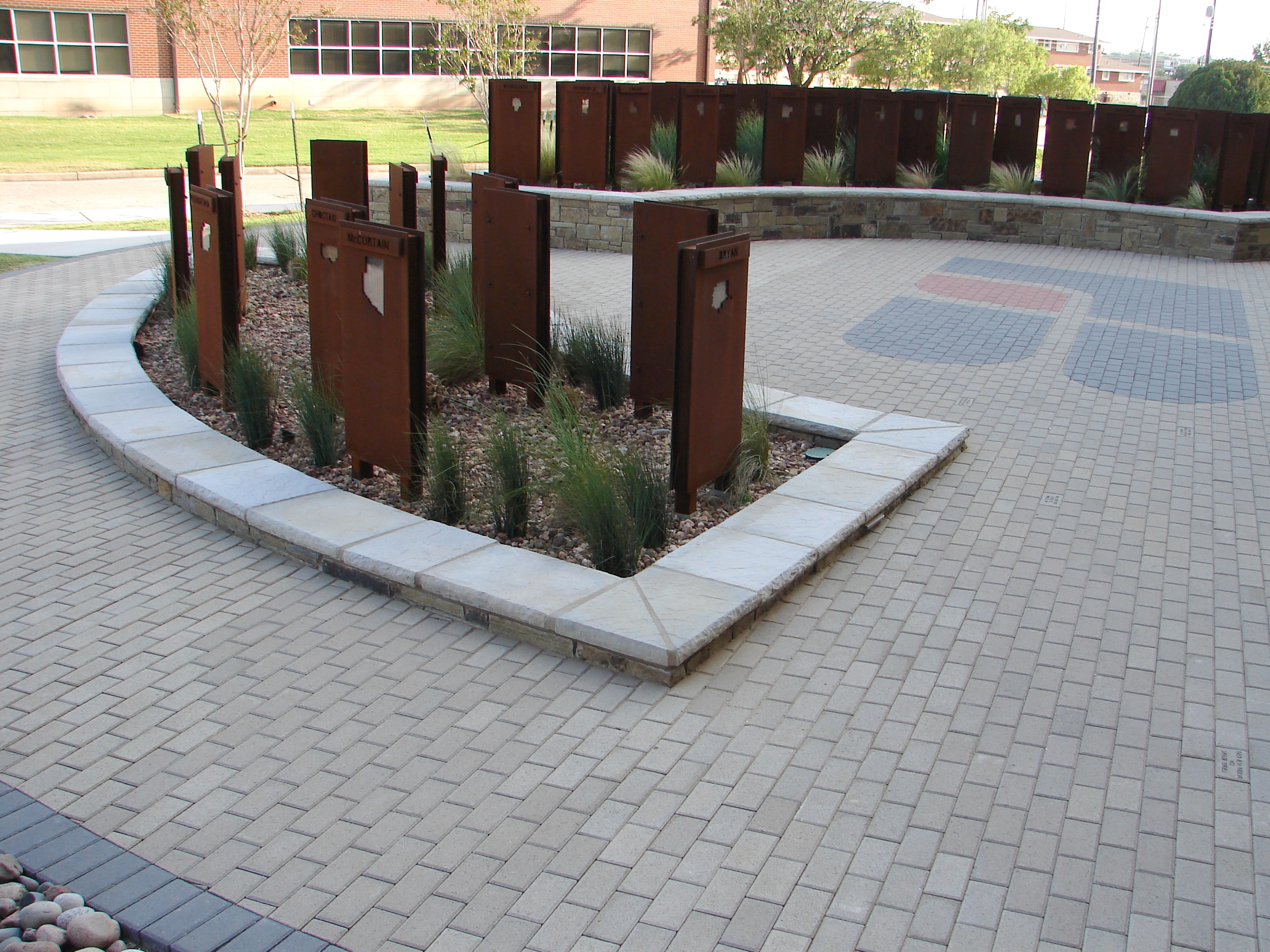 Farm Bureau courtyard with corten steel state markers and paver plaza